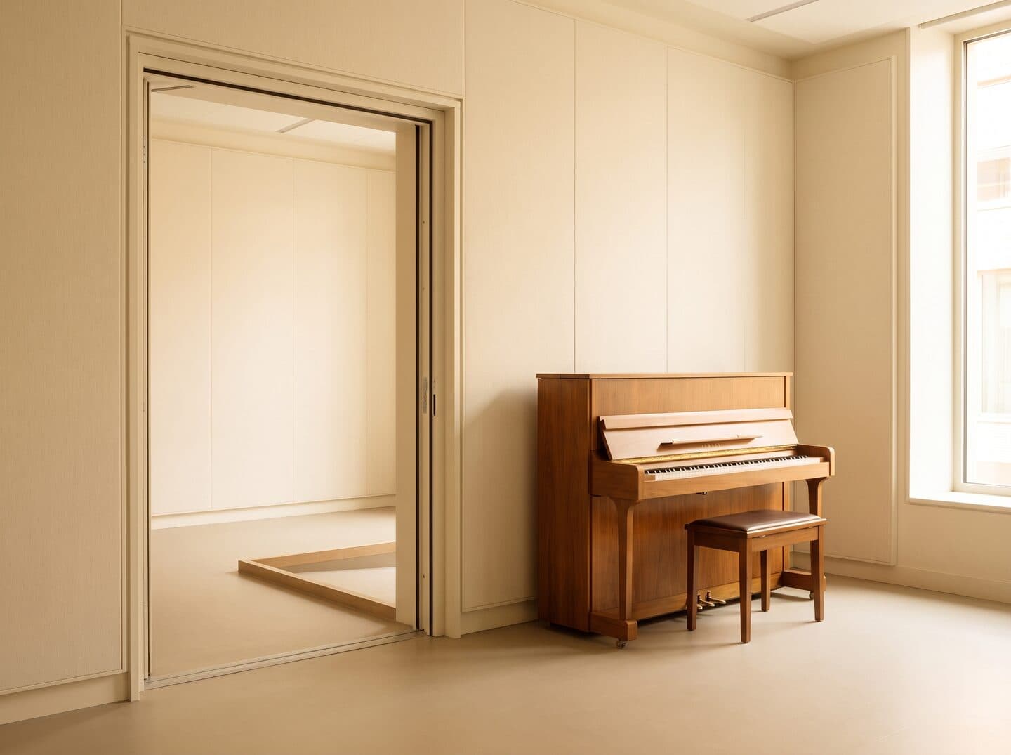 An accessible MS Academy practice room with an upright piano, wide doorway and level flooring