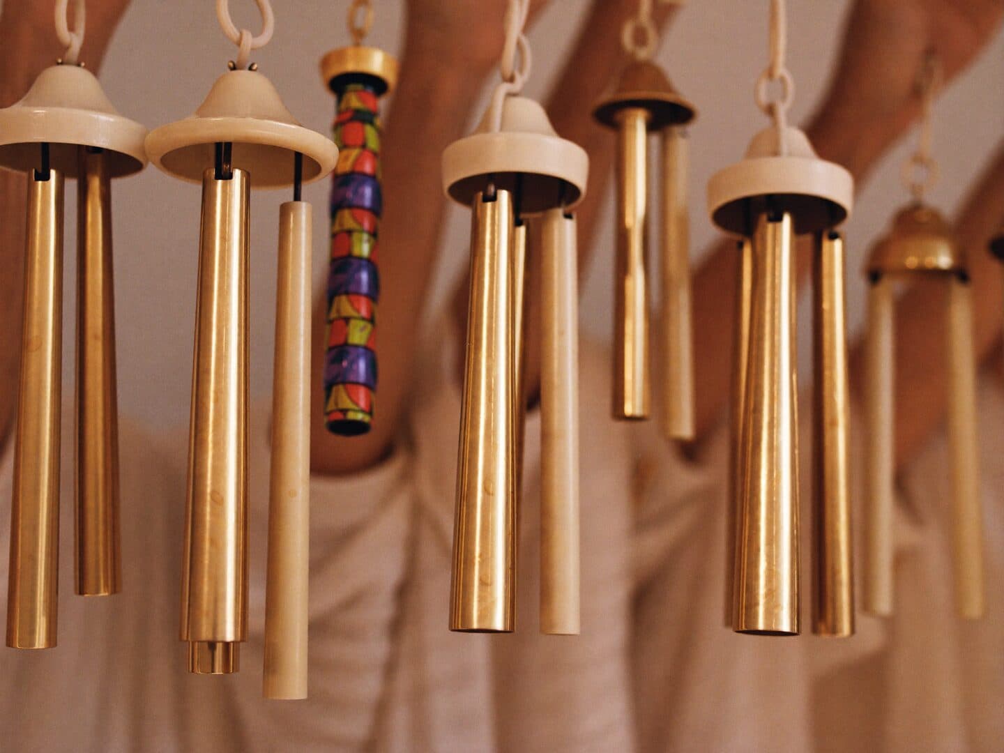 Ensemble members holding handchimes raised, ready to ring their notes together