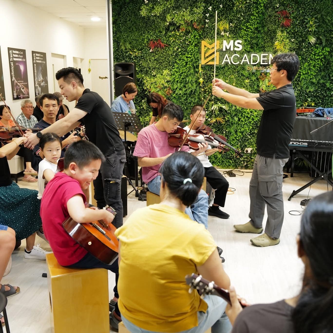 A small string ensemble rehearsing together in a bright studio